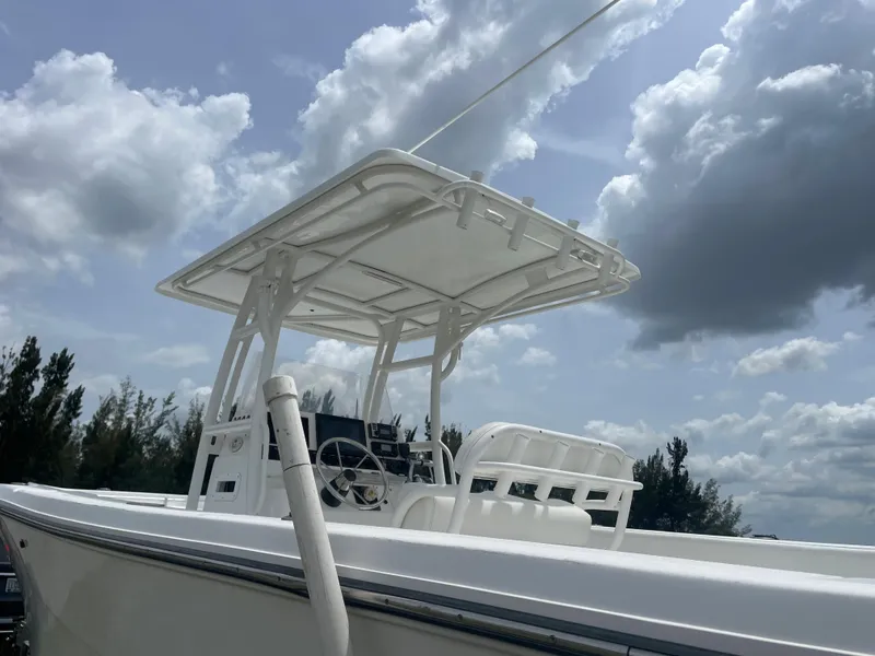 Slide: The Image of 2006 Angler 2900CC boat with T-top under a cloudy sky. - 13