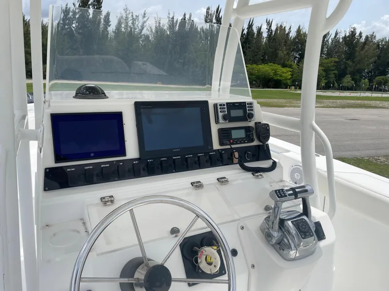 Slide: The Image of 2006 Angler 2900CC boat dashboard with steering wheel, navigation screens, and control panel. - 17