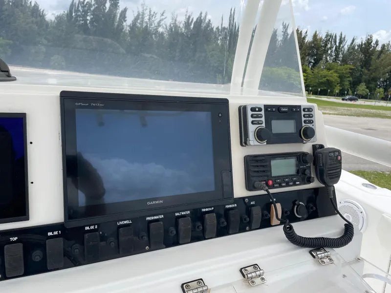 Slide: The Image of 2006 Angler 2900CC boat dashboard with Garmin GPS, radio, and control switches. - 18