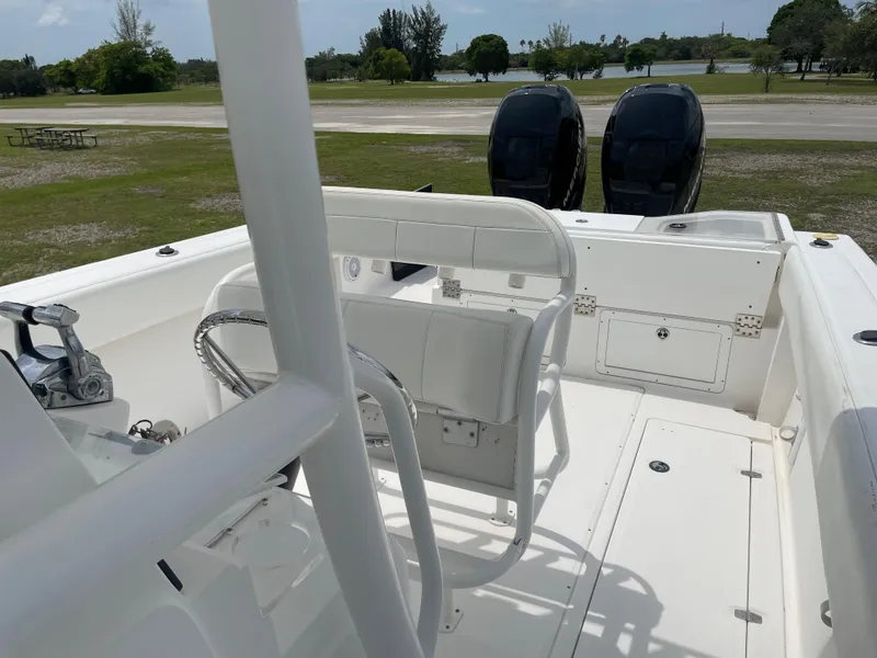 Slide: The Image of 2006 Angler 2900CC boat with dual outboard motors, white interior, and spacious deck. - 22