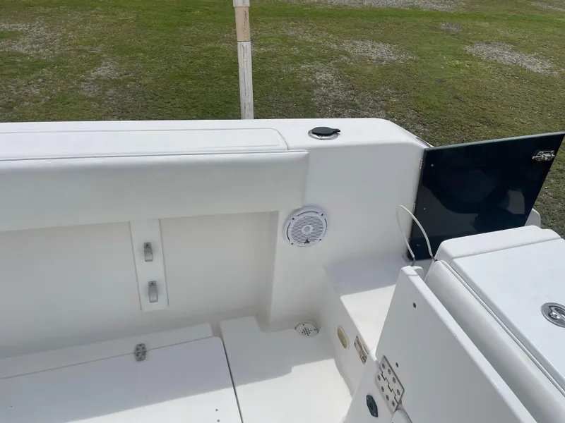 Slide: The Image of 2006 Angler 2900CC boat interior, white seating and storage compartments. - 25