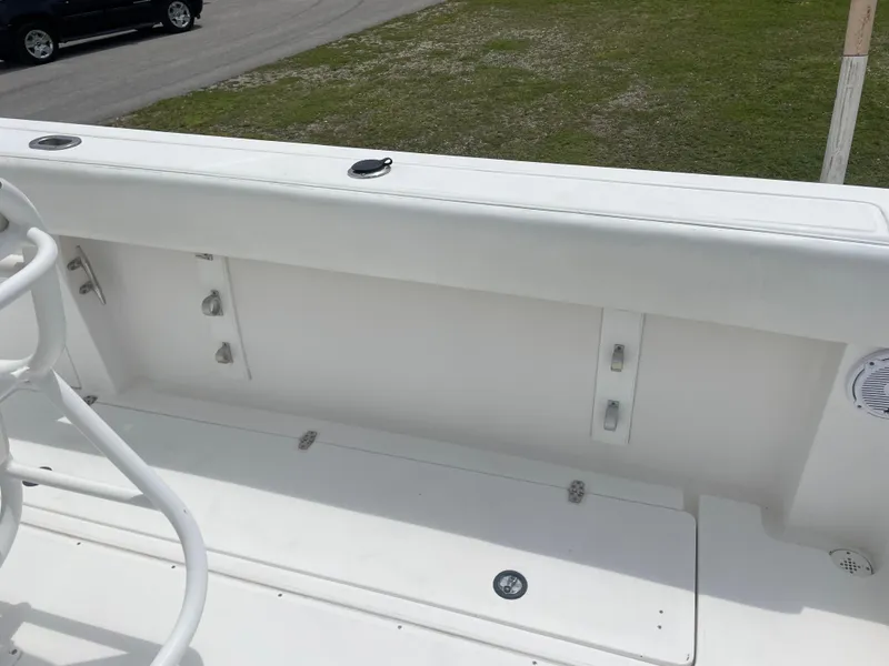 Slide: The Image of 2006 Angler 2900CC boat interior, white seating and deck. - 26