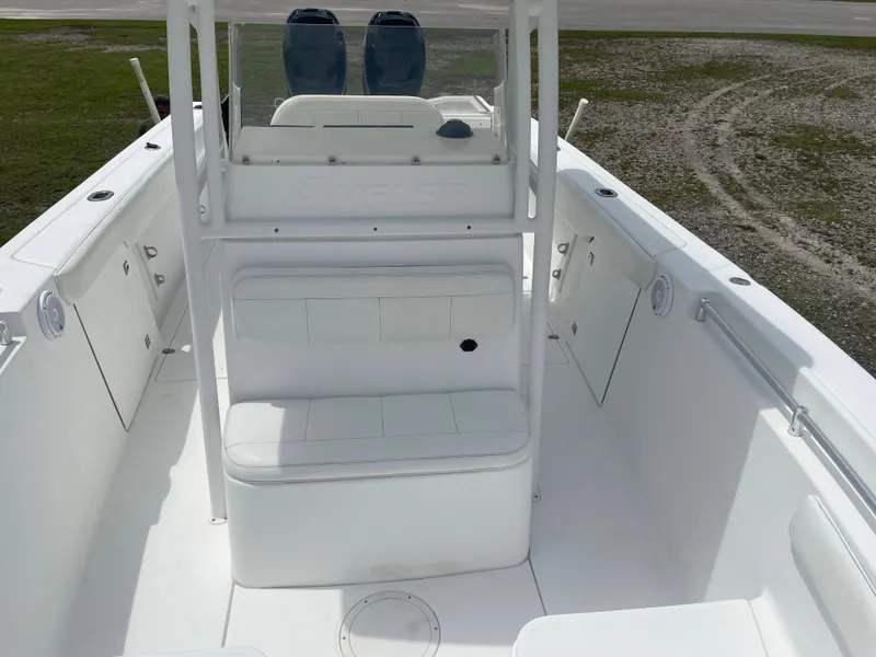 Slide: The Image of 2006 Angler 2900CC boat interior with white seating and console. - 27