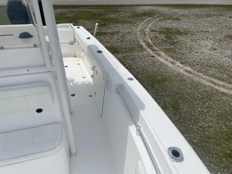 Slide: The Image of 2006 Angler 2900CC boat deck with white seating and storage compartments. - 29