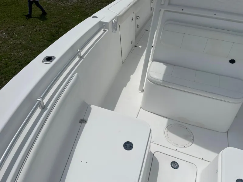 Slide: The Image of 2006 Angler 2900CC boat interior with white seating and storage compartments. - 30