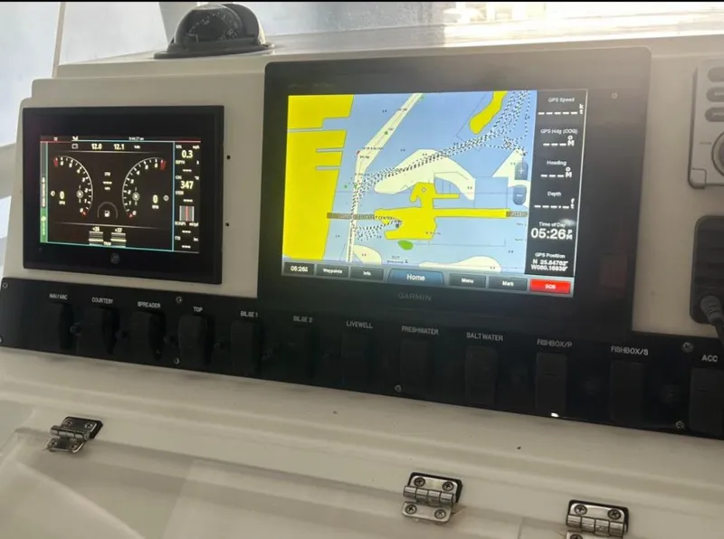 Slide: The Image of 2006 Angler 2900CC boat dashboard with navigation and engine display screens. - 34
