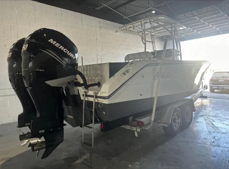 Slide: The Image of 2006 Angler 2900CC boat with twin Mercury engines on a trailer. - 37
