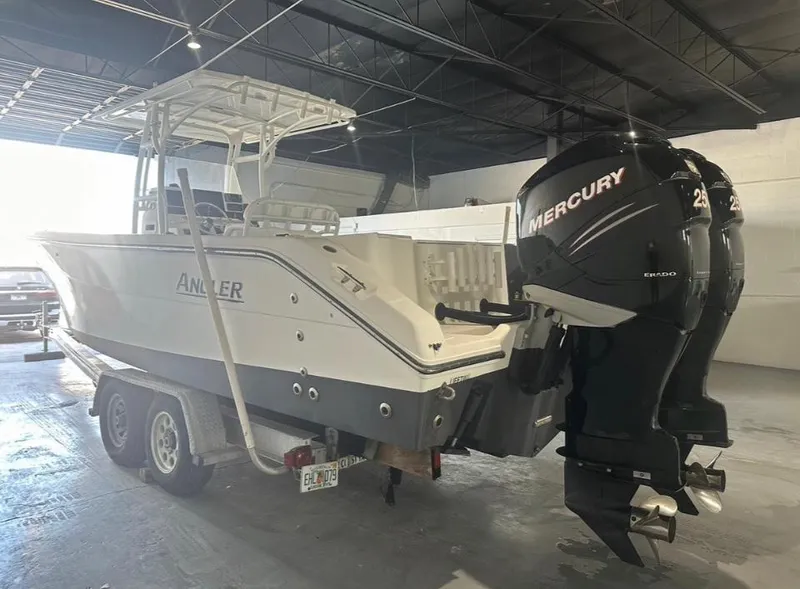 Slide: The Image of 2006 Angler 2900CC boat with twin Mercury engines in a warehouse. - 38