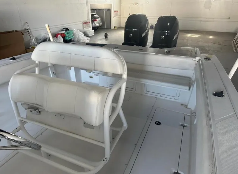 Slide: The Image of 2006 Angler 2900CC boat interior with dual outboard motors in a garage. - 39