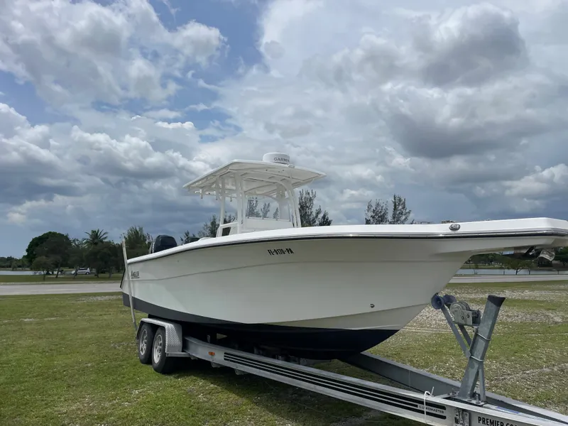 Slide: The Image of 2006 Angler 2900CC boat on a trailer under a cloudy sky. - 4