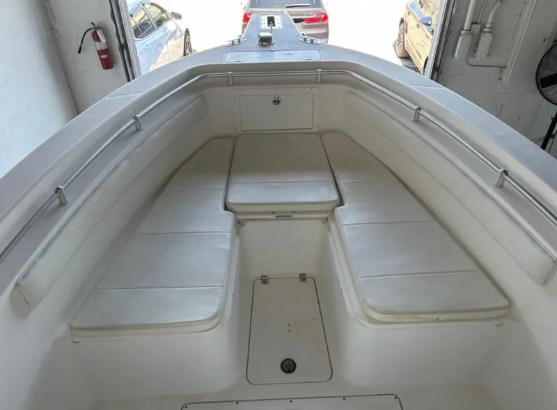 Slide: The Image of 2006 Angler 2900CC boat interior with cushioned seating and storage compartments. - 42