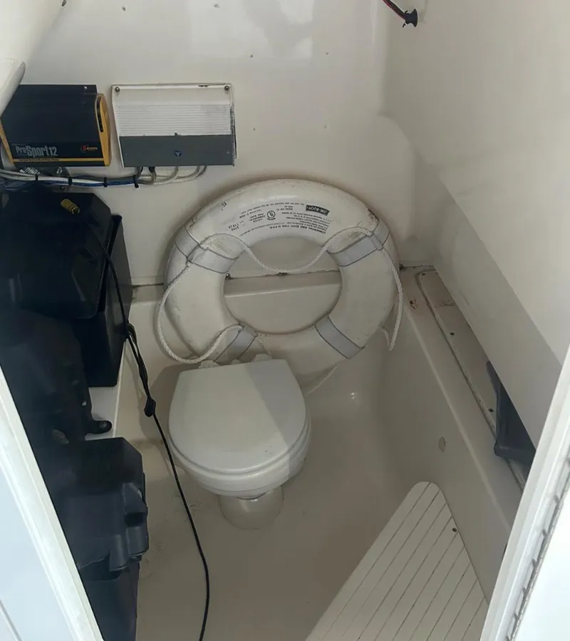 Slide: The Image of 2006 Angler 2900CC boat interior with toilet and life preserver. - 43
