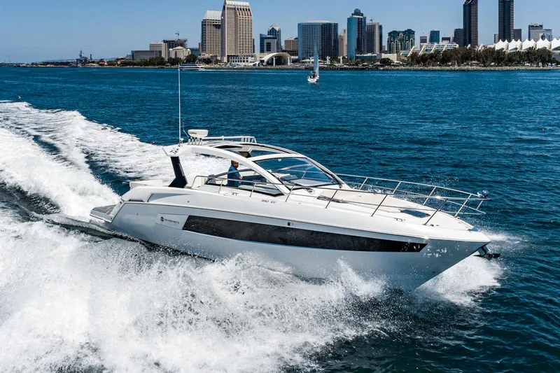 Slide: The Image of 2017 Cruisers Yachts 390 Express Coupe cruising in a city harbor. - 0