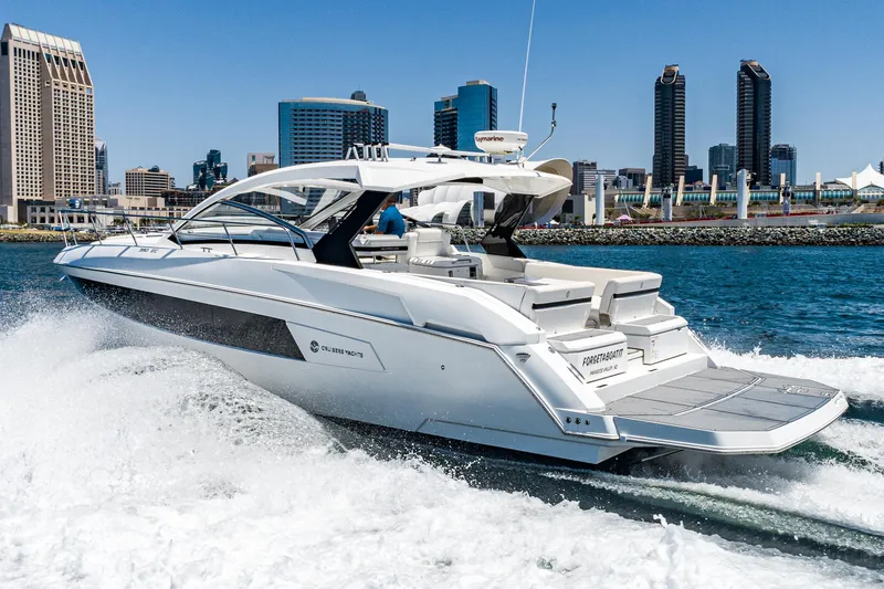 Slide: The Image of 2017 Cruisers Yachts 390 Express Coupe cruising near city skyline. - 1