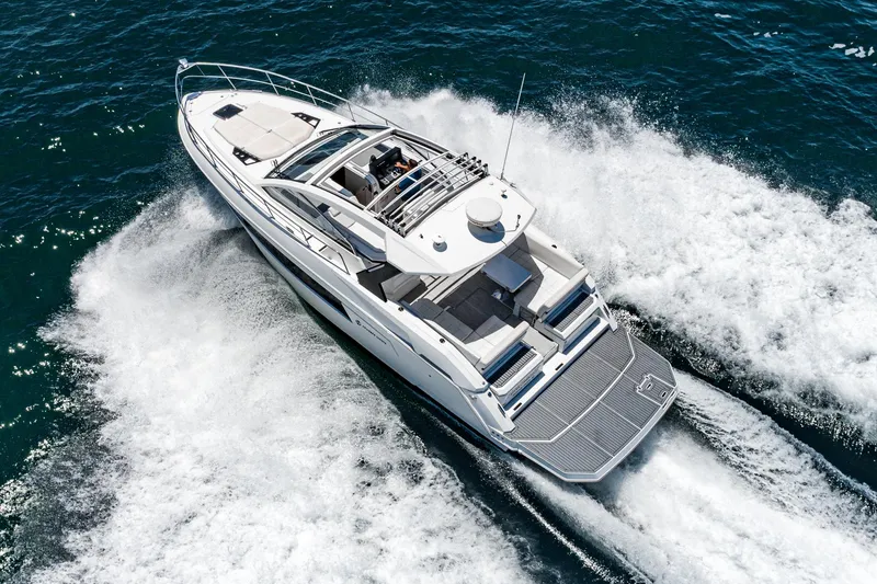 Slide: The Image of 2017 Cruisers Yachts 390 Express Coupe speeding on open water. - 11