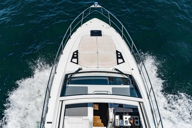 Slide: The Image of 2017 Cruisers Yachts 390 Express Coupe cruising on water, aerial view. - 12