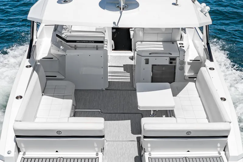 Slide: The Image of 2017 Cruisers Yachts 390 Express Coupe, spacious deck with white seating and table. - 16