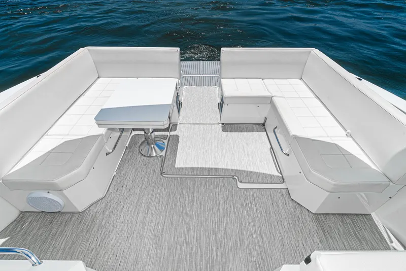 Slide: The Image of 2017 Cruisers Yachts 390 Express Coupe deck with white seating and table. - 18