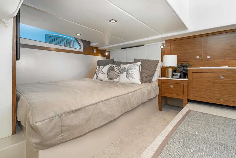 Slide: The Image of 2017 Cruisers Yachts 390 Express Coupe bedroom with modern decor and natural light. - 32