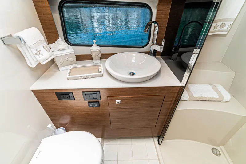 Slide: The Image of 2017 Cruisers Yachts 390 Express Coupe bathroom with sink, toilet, and shower. - 34