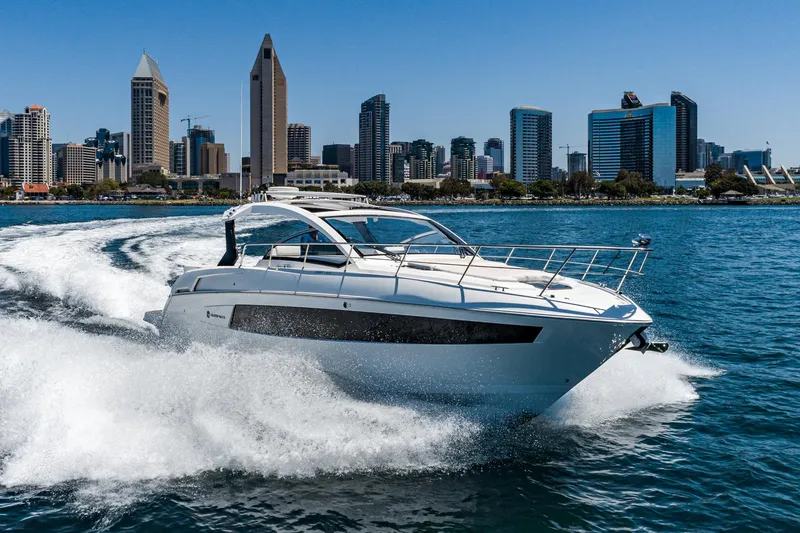 Slide: The Image of 2017 Cruisers Yachts 390 Express Coupe cruising near city skyline. - 5