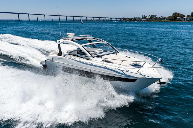Slide: The Image of 2017 Cruisers Yachts 390 Express Coupe speeding on open water. - 6