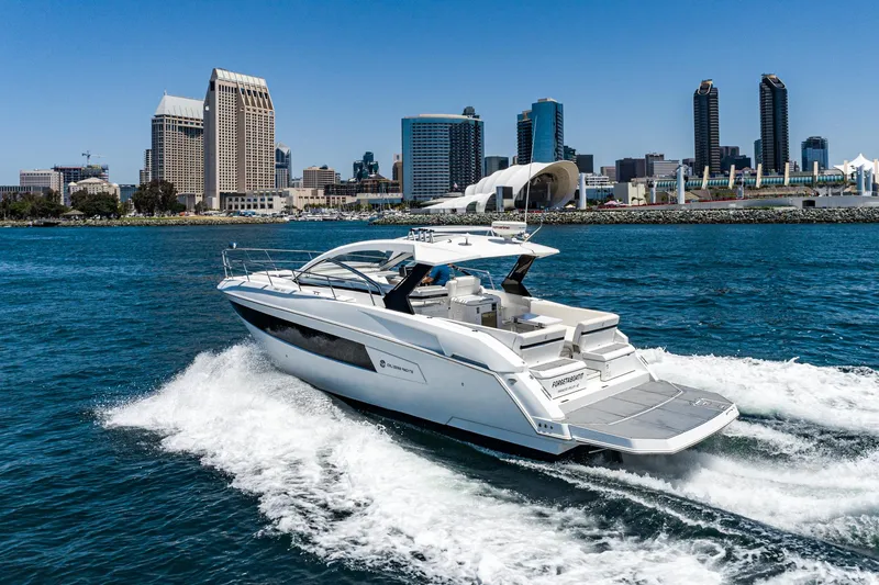 Slide: The Image of 2017 Cruisers Yachts 390 Express Coupe cruising near city skyline. - 7