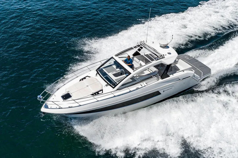 Slide: The Image of 2017 Cruisers Yachts 390 Express Coupe cruising on open water. - 8