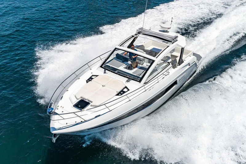 Slide: The Image of 2017 Cruisers Yachts 390 Express Coupe speeding on open water. - 9