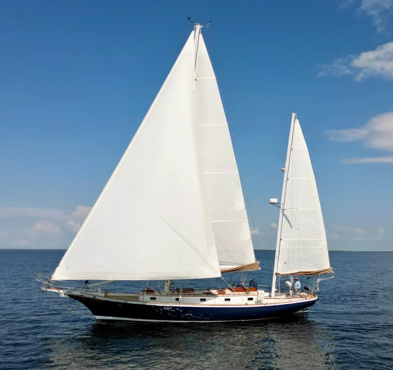 The Image of 1986 Cherubini 44 sailboat on calm ocean under clear blue sky. - 0
