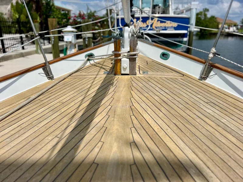 Slide: The Image of Deck of 1986 Cherubini 44 sailboat with wooden planks and rigging. - 10