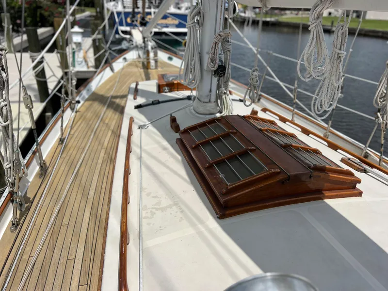 Slide: The Image of 1986 Cherubini 44 sailboat deck with wooden accents and rigging. - 13