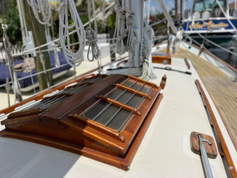 Slide: The Image of 1986 Cherubini 44 sailboat deck with wooden hatch and rigging. - 16