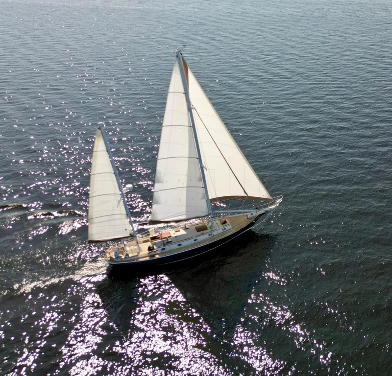 Slide: The Image of Aerial view of 1986 Cherubini 44 sailboat gliding on sparkling water. - 2