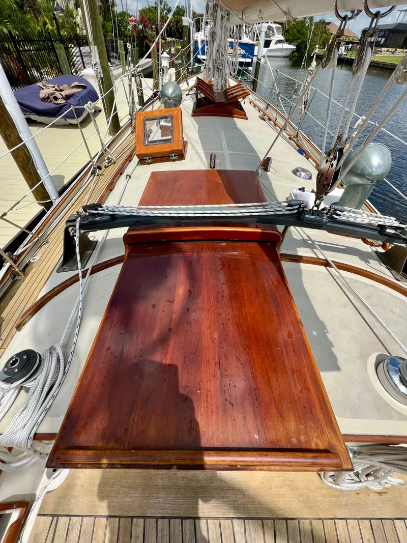 Slide: The Image of 1986 Cherubini 44 sailboat deck with wooden hatches and rigging. - 22