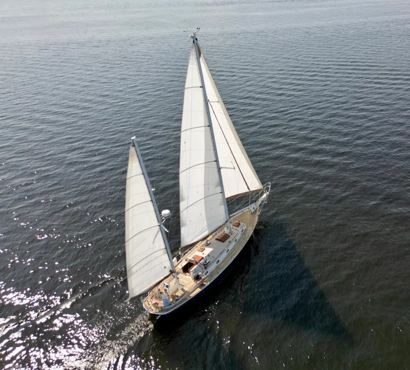 Slide: The Image of Aerial view of a 1986 Cherubini 44 sailboat cruising on open water. - 3