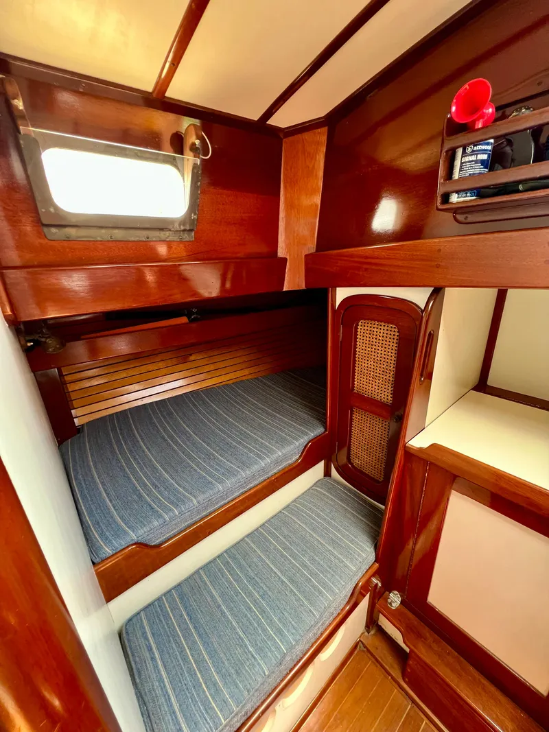 Slide: The Image of 1986 Cherubini 44 yacht interior with wooden bunk beds and nautical decor. - 34