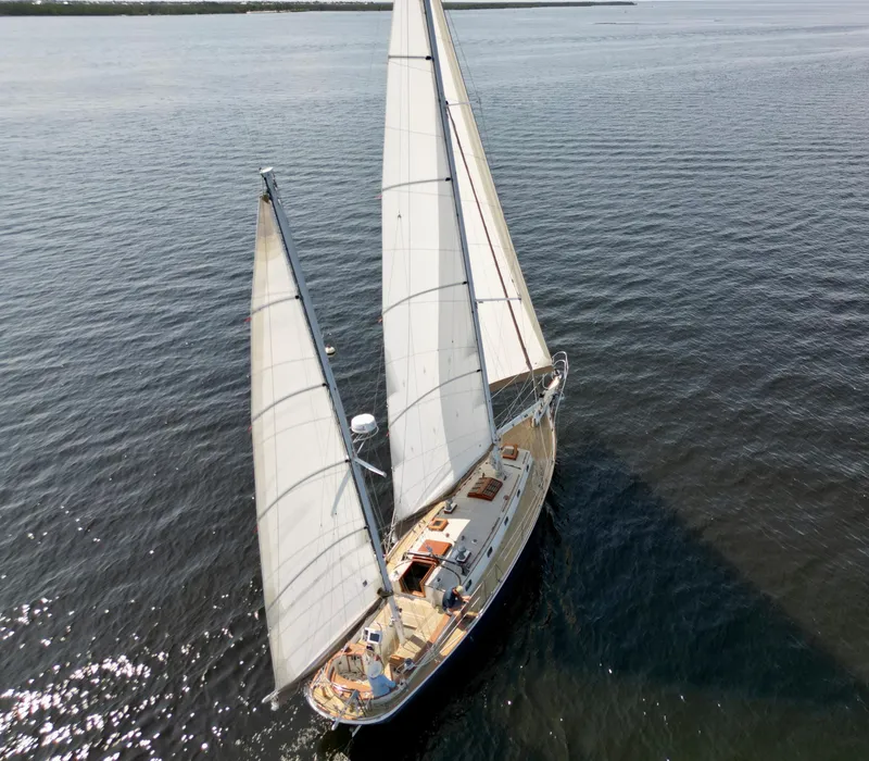 Slide: The Image of Aerial view of a 1986 Cherubini 44 sailboat cruising on calm waters. - 4