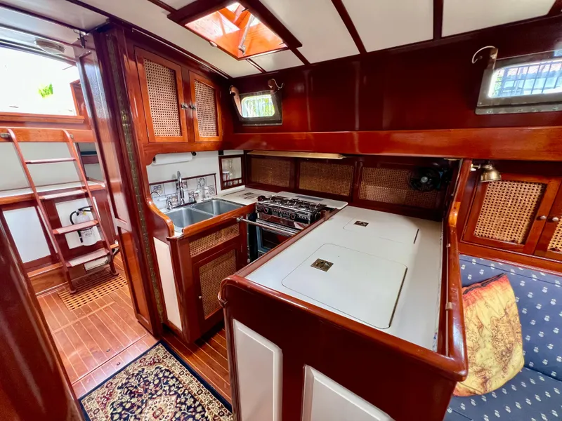 Slide: The Image of Interior of 1986 Cherubini 44 sailboat with wooden cabinetry and galley kitchen. - 43