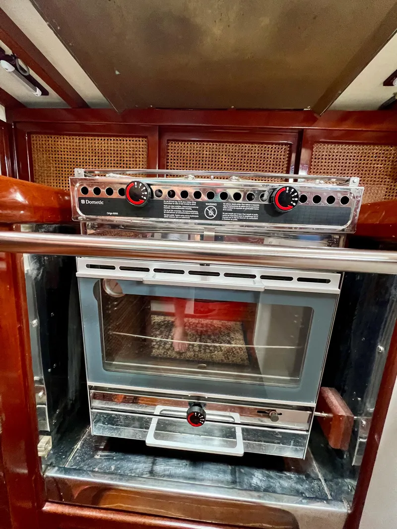 Slide: The Image of 1986 Cherubini 44 yacht kitchen with a built-in oven and stove. - 44