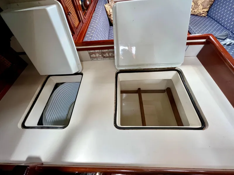 Slide: The Image of Cherubini 44 yacht galley with open storage compartments, 1986 model. - 47