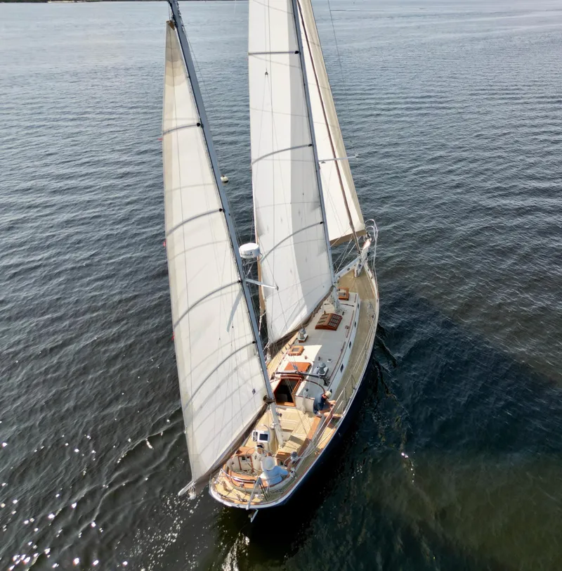 Slide: The Image of Aerial view of a 1986 Cherubini 44 sailboat cruising on calm waters. - 5
