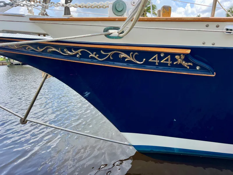 Slide: The Image of Cherubini 44 sailboat, 1986 model, detailed bow design, docked on calm water. - 7