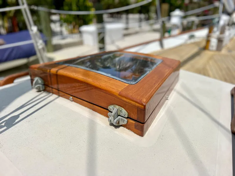 Slide: The Image of Close-up of a 1986 Cherubini 44 sailboat's wooden deck hatch. - 9