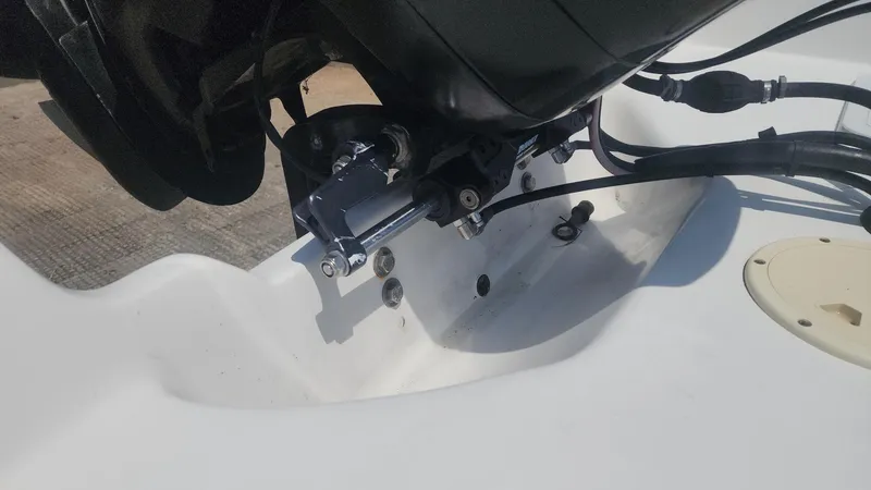 Slide: The Image of 1976 Boston Whaler 17 Montauk boat engine detail with cables and mounting components. - 19