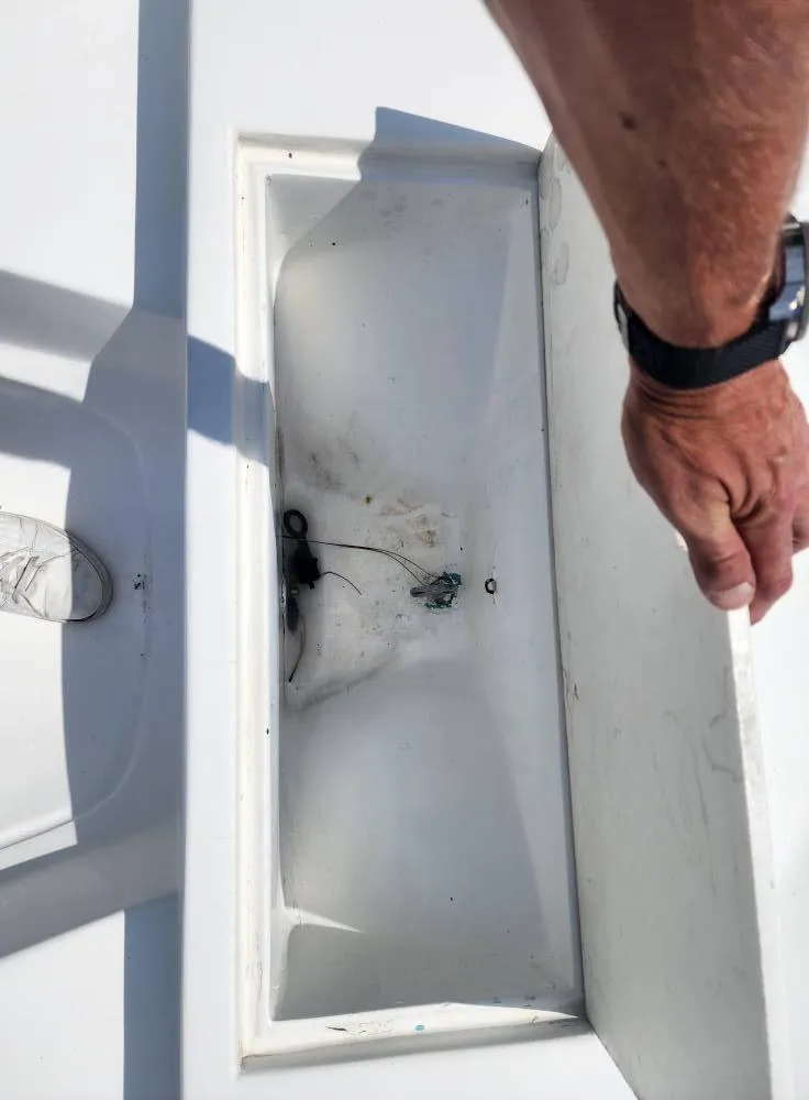 Slide: The Image of 1976 Boston Whaler 17 Montauk storage compartment with open lid, showing interior details. - 27