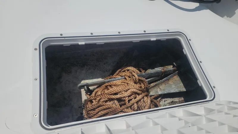 Slide: The Image of Anchor and rope in storage compartment of 1976 Boston Whaler 17 Montauk boat. - 28