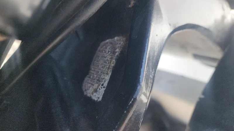 Slide: The Image of Close-up of a worn label on a 1976 Boston Whaler 17 Montauk boat. - 34