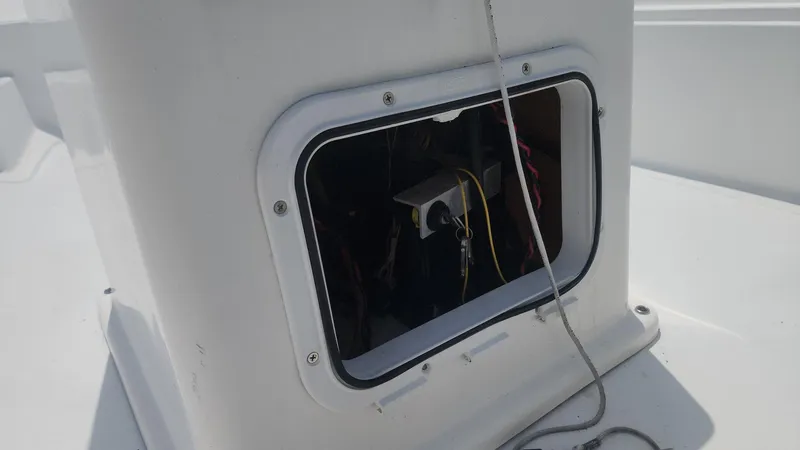 Slide: The Image of 1976 Boston Whaler 17 Montauk boat console with open access panel and visible wiring. - 43