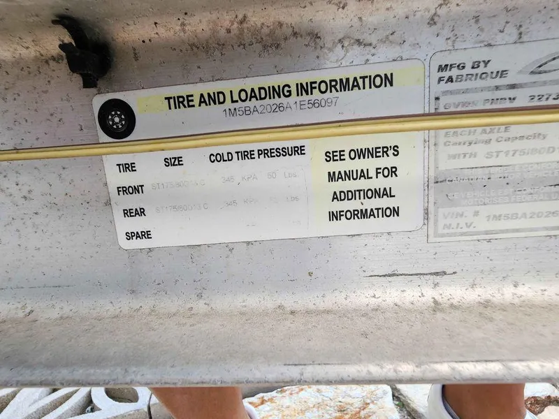 Slide: The Image of Tire and loading information label on a 1976 Boston Whaler 17 Montauk boat. - 6